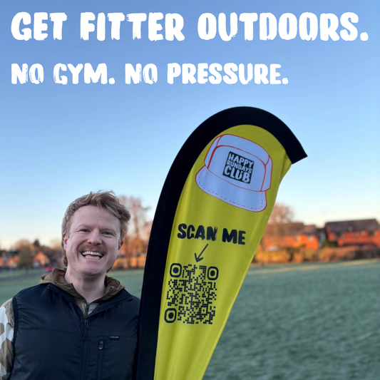 Ben from Happy Rundays Club standing beside branded flag at an outdoor fitness session in stone promoting beginner friendly outdoor training.